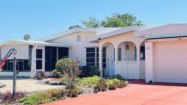 409 Bryn Mawr Is, Bradenton, FL 34207 - view of front of house featuring a garage, a sunroom, concrete driveway, and stucco siding