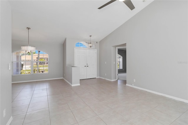 251 Broadmoor Ln, Rotonda West, FL 33947 - spare room with a ceiling fan, light tile patterned floors, high vaulted ceiling, and baseboards