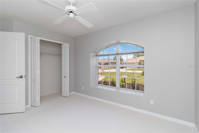 251 Broadmoor Ln, Rotonda West, FL 33947 - unfurnished bedroom with carpet, a closet, baseboards, and a ceiling fan