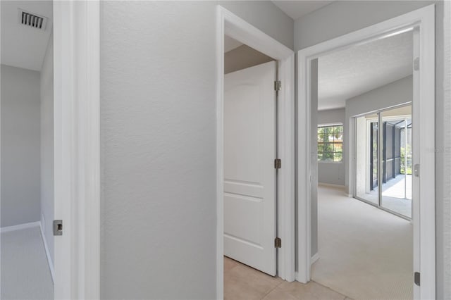 251 Broadmoor Ln, Rotonda West, FL 33947 - corridor with light colored carpet, light tile patterned floors, and baseboards