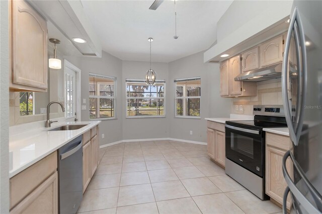 251 Broadmoor Ln, Rotonda West, FL 33947 - kitchen featuring appliances with stainless steel finishes, under cabinet range hood, a sink, light brown cabinetry, and recessed lighting