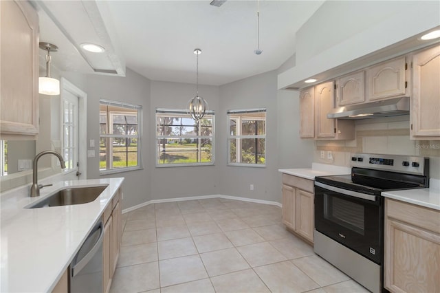 251 Broadmoor Ln, Rotonda West, FL 33947 - kitchen featuring stainless steel appliances, a sink, light brown cabinets, under cabinet range hood, and light countertops