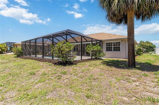 251 Broadmoor Ln, Rotonda West, FL 33947 - rear view of property with a yard, a lanai, and stucco siding