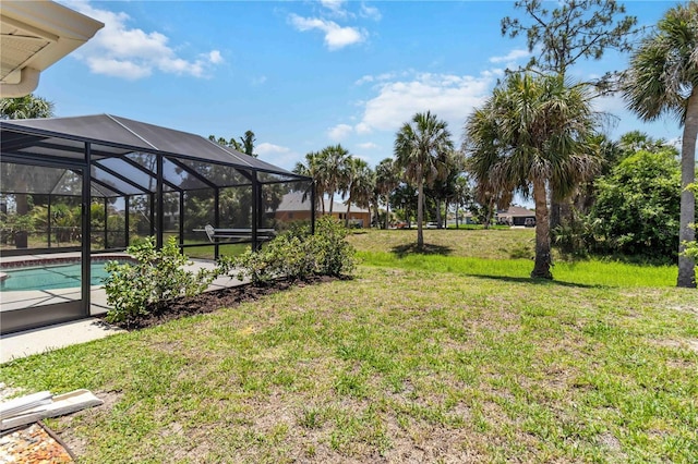 251 Broadmoor Ln, Rotonda West, FL 33947 - view of green lawn with an outdoor pool and glass enclosure