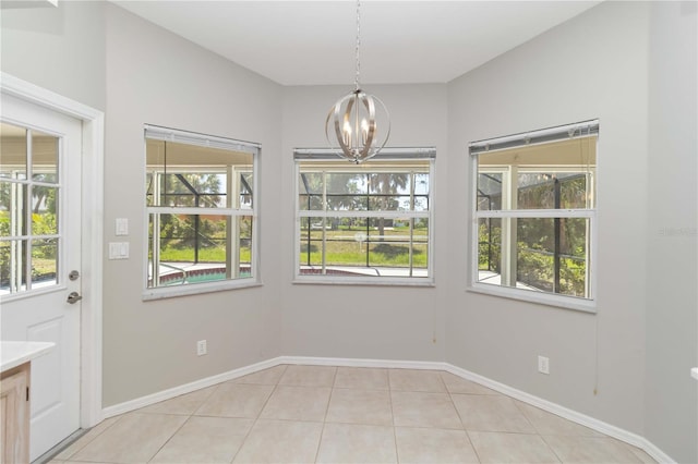 251 Broadmoor Ln, Rotonda West, FL 33947 - unfurnished dining area featuring a chandelier, plenty of natural light, light tile patterned flooring, and baseboards
