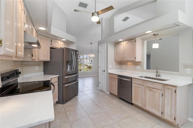251 Broadmoor Ln, Rotonda West, FL 33947 - kitchen with appliances with stainless steel finishes, a sink, under cabinet range hood, light brown cabinetry, and lofted ceiling