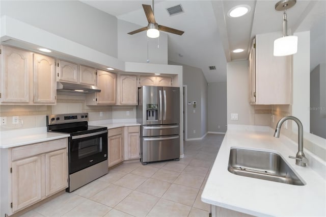 251 Broadmoor Ln, Rotonda West, FL 33947 - kitchen featuring stainless steel appliances, a sink, under cabinet range hood, light brown cabinetry, and vaulted ceiling