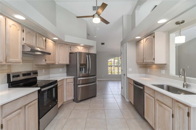 251 Broadmoor Ln, Rotonda West, FL 33947 - kitchen featuring appliances with stainless steel finishes, under cabinet range hood, a sink, light brown cabinets, and backsplash