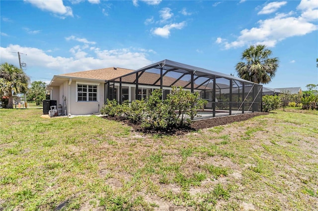 251 Broadmoor Ln, Rotonda West, FL 33947 - back of house with a yard, a lanai, stucco siding, and an outdoor pool