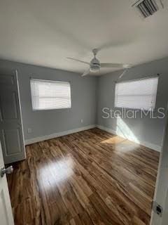 unfurnished bedroom featuring wood finished floors, baseboards, and ceiling fan