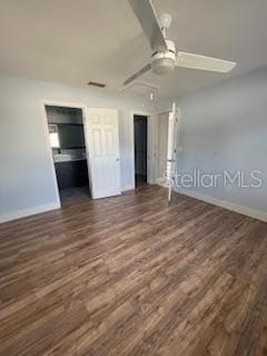 unfurnished bedroom with baseboards, wood finished floors, and ceiling fan