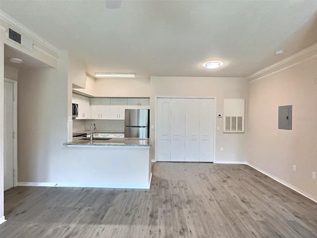 4142 Central Sarasota Pkwy Unit 1423, Sarasota, FL 34238 - kitchen with stainless steel appliances, ornamental molding, electric panel, light wood-style flooring, and a sink