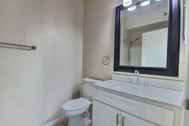 4142 Central Sarasota Pkwy Unit 1423, Sarasota, FL 34238 - bathroom featuring a textured wall, toilet, vanity, tile patterned flooring, and a shower