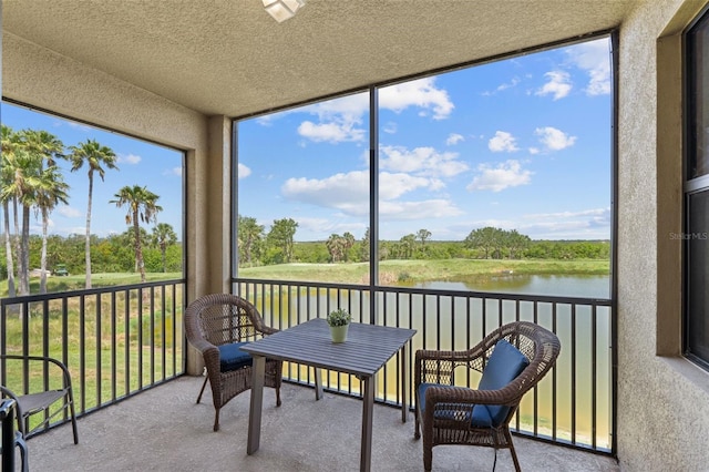 7005 River Hammock Dr Unit 203, Bradenton, FL 34212 - sunroom / solarium featuring a water view, healthy amount of natural light, and view of scattered trees