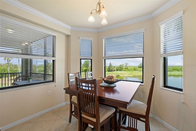 7005 River Hammock Dr Unit 203, Bradenton, FL 34212 - dining space with baseboards, a chandelier, ornamental molding, and light tile patterned flooring