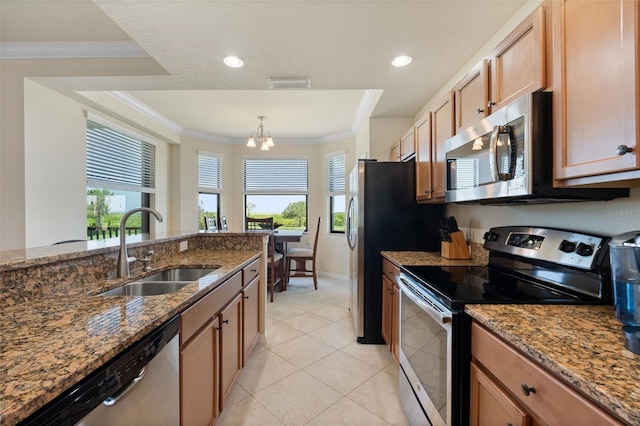 7005 River Hammock Dr Unit 203, Bradenton, FL 34212 - kitchen with stainless steel appliances, a sink, healthy amount of natural light, dark stone countertops, and crown molding