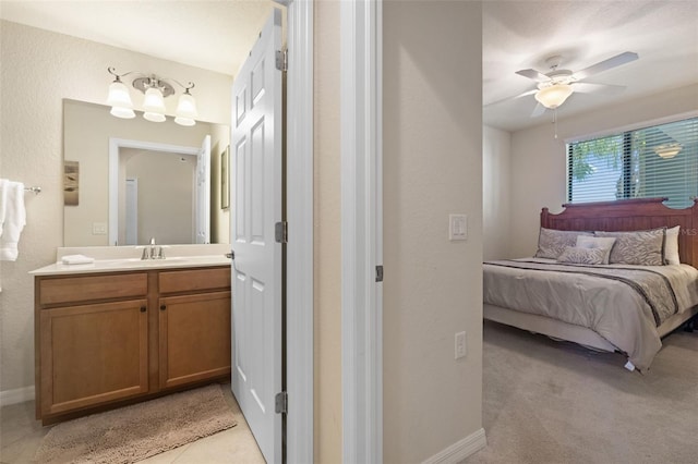 7005 River Hammock Dr Unit 203, Bradenton, FL 34212 - bedroom with a sink, ceiling fan, connected bathroom, and baseboards