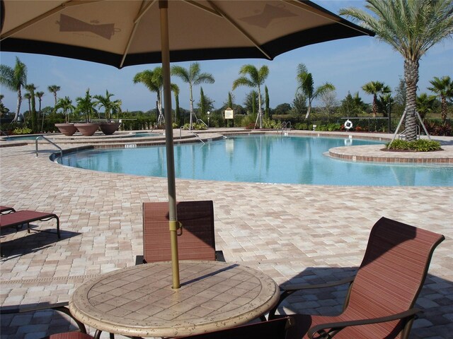 7005 River Hammock Dr Unit 203, Bradenton, FL 34212 - community pool with a jacuzzi and a patio area