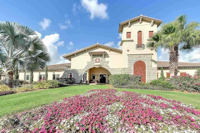 7005 River Hammock Dr Unit 203, Bradenton, FL 34212 - mediterranean / spanish house featuring stone siding, stucco siding, and a front yard