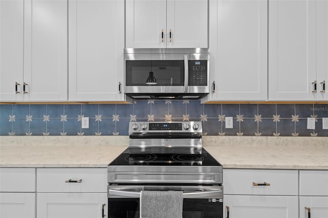 5816 Mezzana Run, Palmetto, FL 34221 - kitchen featuring appliances with stainless steel finishes, white cabinetry, backsplash, and light stone counters
