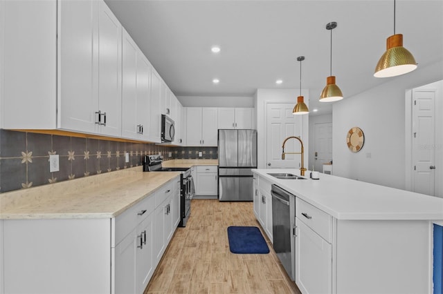 5816 Mezzana Run, Palmetto, FL 34221 - kitchen with appliances with stainless steel finishes, a sink, light countertops, recessed lighting, and backsplash