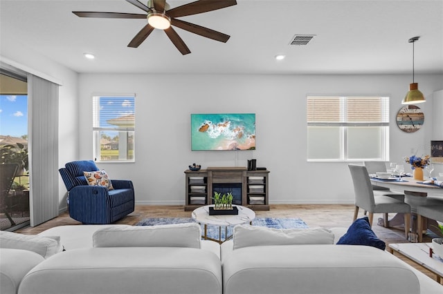 5816 Mezzana Run, Palmetto, FL 34221 - living room with plenty of natural light, ceiling fan, wood finished floors, baseboards, and recessed lighting