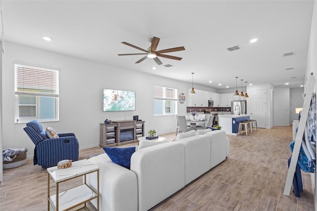 5816 Mezzana Run, Palmetto, FL 34221 - living room featuring recessed lighting, ceiling fan, light wood-style floors, and baseboards