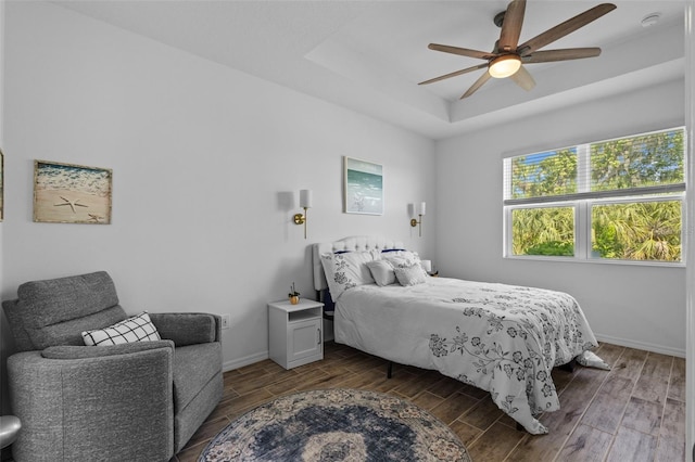 5816 Mezzana Run, Palmetto, FL 34221 - bedroom with a tray ceiling, wood finished floors, baseboards, and ceiling fan