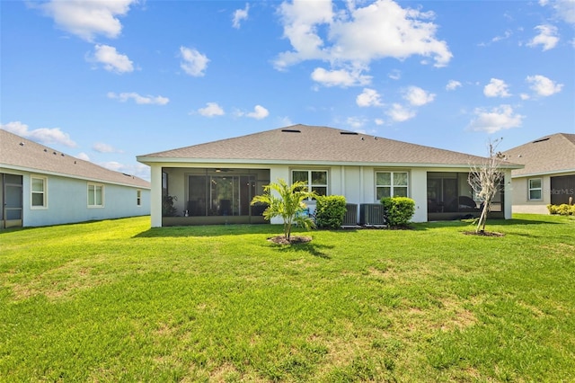 5816 Mezzana Run, Palmetto, FL 34221 - rear view of house with a sunroom, a lawn, and central air condition unit