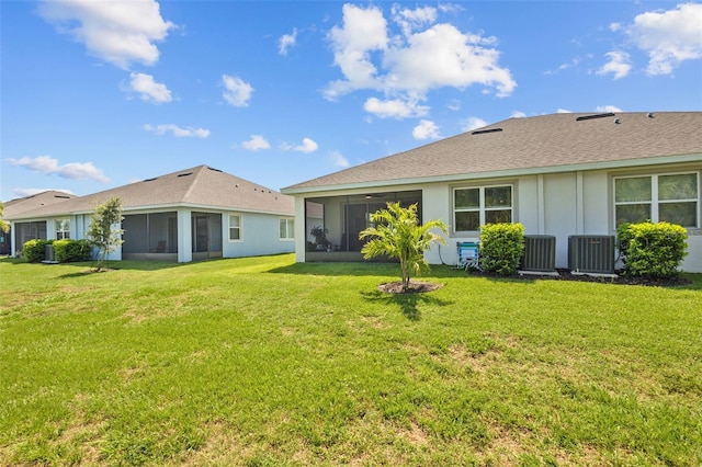 5816 Mezzana Run, Palmetto, FL 34221 - back of property with a sunroom, a lawn, and central AC