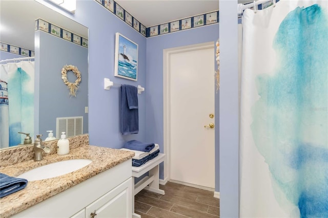 2801 Dalhart Ave, North Port, FL 34286 - full bathroom with wood tiled floors, vanity, baseboards, and a shower with curtain