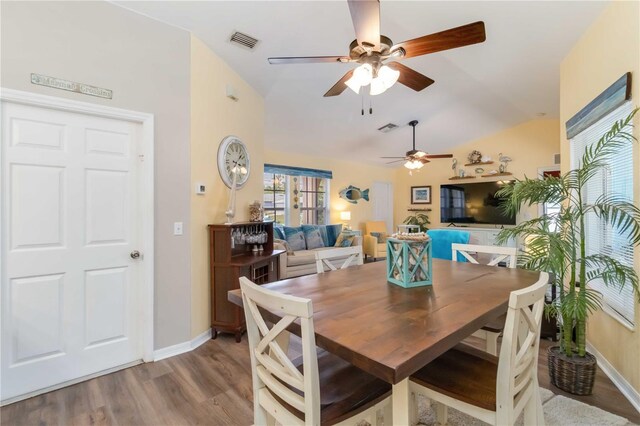 2801 Dalhart Ave, North Port, FL 34286 - dining space featuring a ceiling fan, vaulted ceiling, wood finished floors, and baseboards