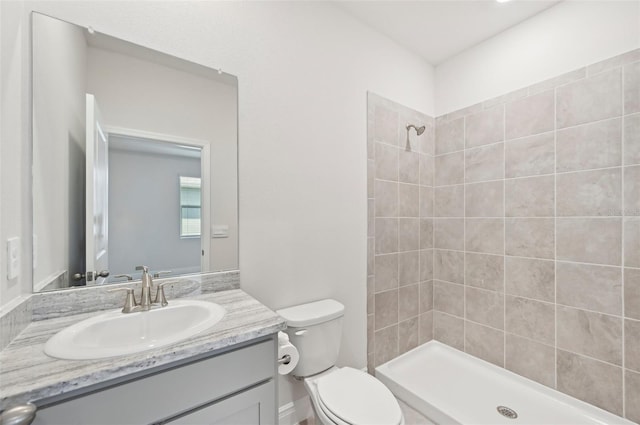 full bath featuring a stall shower, toilet, and vanity