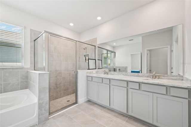 full bathroom featuring a stall shower, a bath, double vanity, tile patterned flooring, and recessed lighting