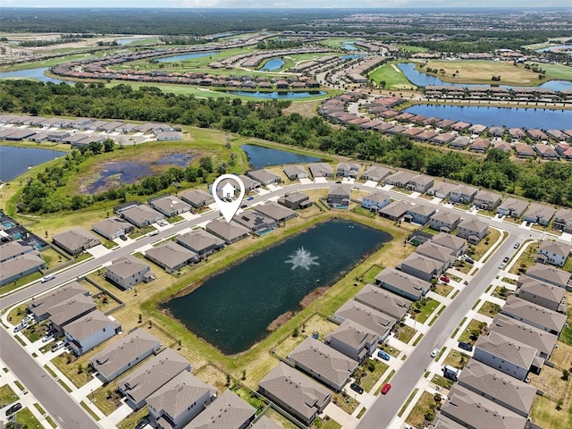 aerial view of property's location featuring nearby suburban area and a nearby body of water