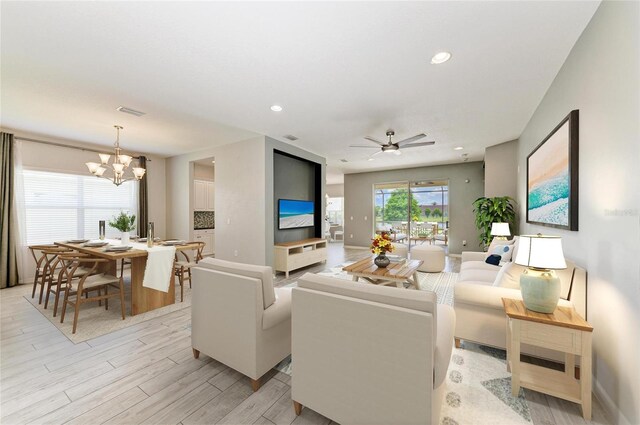 11811 Fennemore Way, Parrish, FL 34219 - living area featuring light wood-style flooring, a chandelier, ceiling fan, recessed lighting, and baseboards