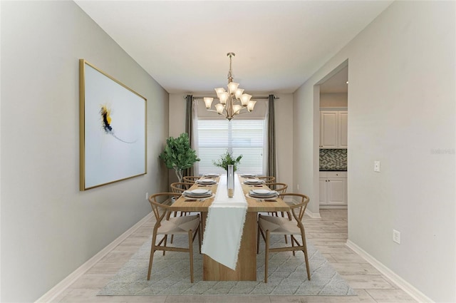 11811 Fennemore Way, Parrish, FL 34219 - dining area featuring a chandelier, light wood finished floors, and baseboards