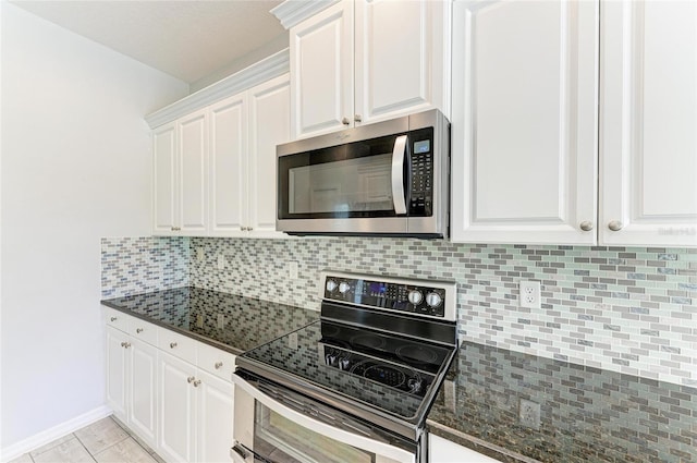 11811 Fennemore Way, Parrish, FL 34219 - kitchen featuring stainless steel appliances, white cabinets, tasteful backsplash, and baseboards