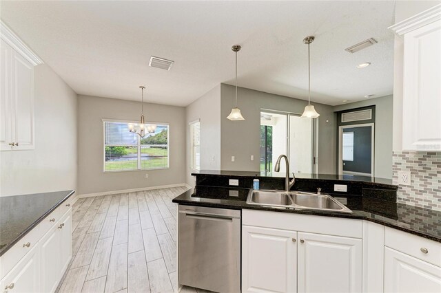 11811 Fennemore Way, Parrish, FL 34219 - kitchen featuring stainless steel dishwasher, a sink, light wood-style flooring, decorative backsplash, and white cabinetry