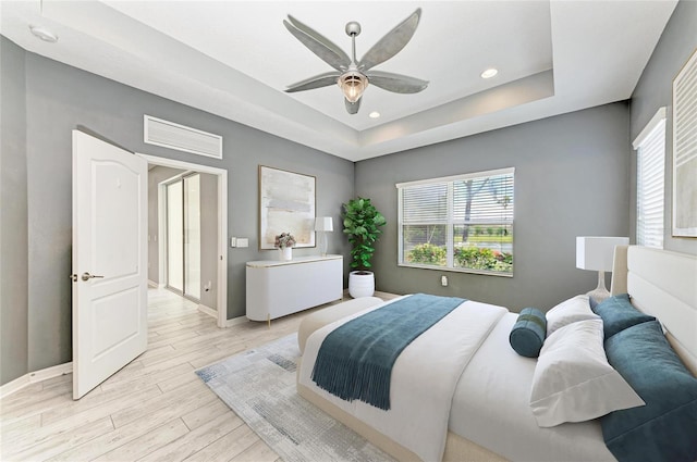 11811 Fennemore Way, Parrish, FL 34219 - bedroom featuring light wood-style flooring, baseboards, a raised ceiling, recessed lighting, and ceiling fan