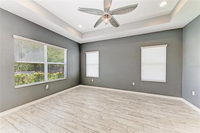 11811 Fennemore Way, Parrish, FL 34219 - unfurnished room with ceiling fan, a tray ceiling, wood finished floors, baseboards, and recessed lighting