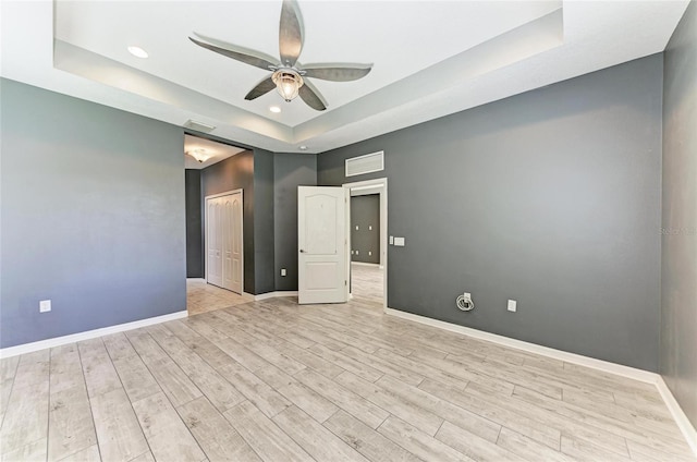 11811 Fennemore Way, Parrish, FL 34219 - empty room with a raised ceiling, ceiling fan, baseboards, light wood-type flooring, and recessed lighting