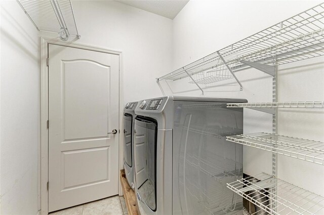 11811 Fennemore Way, Parrish, FL 34219 - washroom with washing machine and clothes dryer and light tile patterned floors
