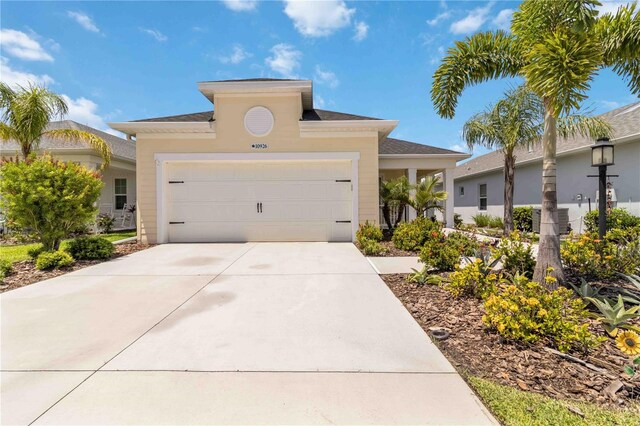10926 Sand Pine Ln, Parrish, FL 34219 - view of front of home featuring concrete driveway and an attached garage