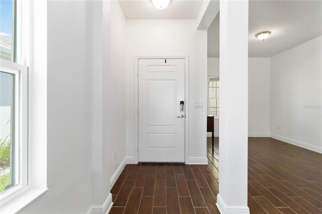 10926 Sand Pine Ln, Parrish, FL 34219 - hallway featuring dark wood-type flooring and baseboards