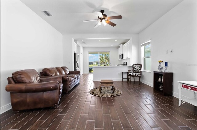 10926 Sand Pine Ln, Parrish, FL 34219 - living room with ceiling fan, dark wood-type flooring, and baseboards