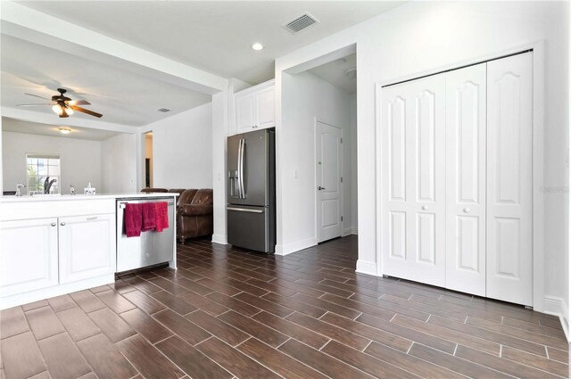 10926 Sand Pine Ln, Parrish, FL 34219 - kitchen featuring appliances with stainless steel finishes, white cabinets, a ceiling fan, open floor plan, and dark wood-style floors