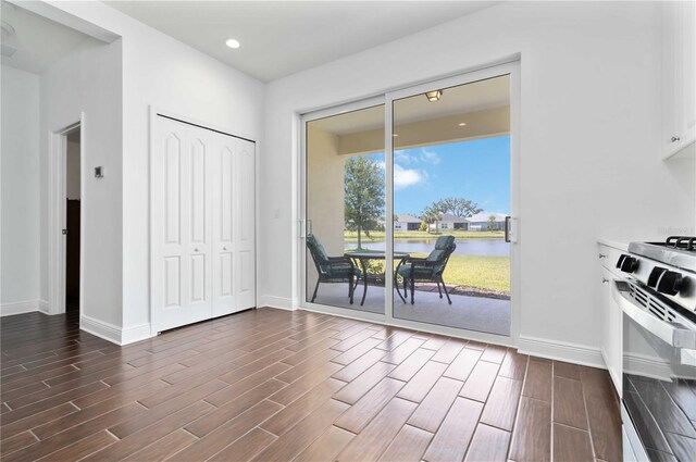 10926 Sand Pine Ln, Parrish, FL 34219 - dining space featuring baseboards, dark wood-type flooring, a water view, and recessed lighting