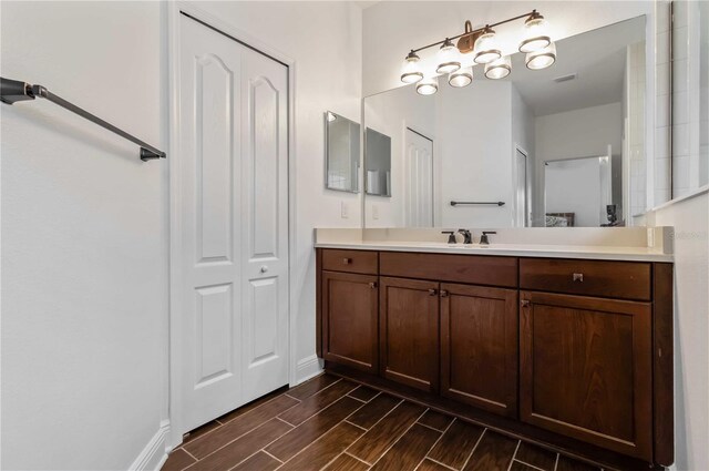 10926 Sand Pine Ln, Parrish, FL 34219 - bathroom featuring wood tiled floors, vanity, and baseboards