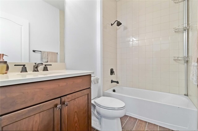 10926 Sand Pine Ln, Parrish, FL 34219 - full bathroom with toilet, vanity, wood finished floors, and tub / shower combination